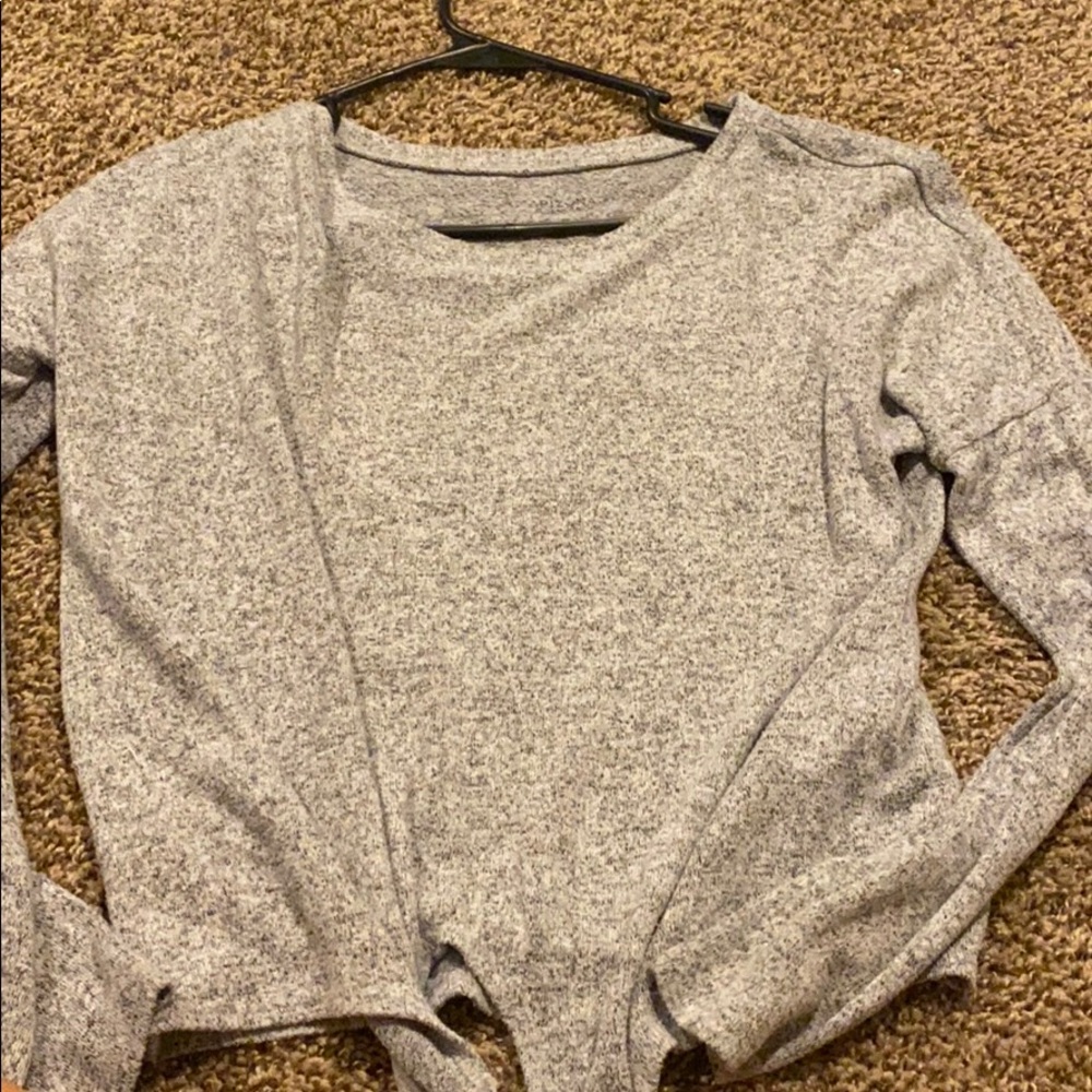 Grey cropped sweater with a tie at the bottom